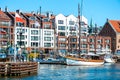 Panoramic view with modern houses and water pier of Gdansk marina at sunset, Poland, Baltic sea. Yachts and ships with flags at