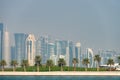 Panoramic view of modern skyline of Doha with Palms foreground. Concept of healthy environment