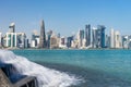 Panoramic view of modern skyline of Doha with small waterfall foreground. Qatar on sunny day