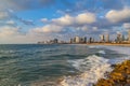 Panoramic view of modern Tel Aviv sky line and beach on sunny day. Mediterranean sea, Israel. Sea waves and cloudy sky Royalty Free Stock Photo