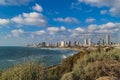 Panoramic view of modern Tel Aviv sky line and beach on sunny day. Mediterranean sea, Israel. Sea waves and cloudy sky Royalty Free Stock Photo