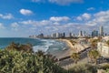 Panoramic view of modern Tel Aviv sky line and beach on sunny day. Mediterranean sea, Israel. Sea waves and cloudy sky Royalty Free Stock Photo