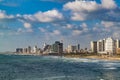 Panoramic view of modern Tel Aviv sky line and beach on sunny day. Mediterranean sea, Israel. Sea waves and cloudy sky Royalty Free Stock Photo