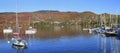 Panoramic view of Mont Tremblant and lake in autumn with colorful yachts on the foreground, Quebec