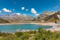 Panoramic view of Montespluga lake on a sunny summer day. The lake is nearly empty due to climate change. Spluga Pass