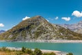 Panoramic view of Montespluga lake on a sunny summer day. The lake is nearly empty due to climate change. Spluga Pass