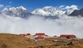 Panoramic view Mount Everest Lhotse and Ama Dablam from Kongde with tourist lodge and beautiful clouds, Sagarmatha national Royalty Free Stock Photo