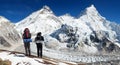 Mount Everest from Pumo Ri base camp with two tourists
