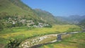 Panoramic view of mountain valley with river, rice fields and small village. Himalayas, India