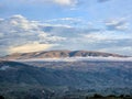 Panoramic view of mountainous Andean meadow with low clouds
