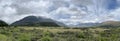 Panoramic view of a mountainous green landscape in New Zealand on a bright summer day Royalty Free Stock Photo