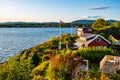 Panoramic view of Nakholmen island on Oslofjord harbor with summer cabin houses at shoreline in early autumn near Oslo, Norway