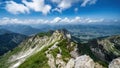 Panoramic view from Nebelhorn in Oberstdorf AllgÃÂ¤u Bavaria Germany - Beautiful Alps with lush green meadow and blue sky -