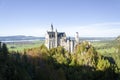 A panoramic view of Neuschwanstein Castle with trees in Bavaria Germany.