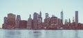 Panoramic view of New York Financial District and the Lower Manhattan at dawn viewed from the Brooklyn Bridge Park. Low contrast