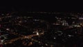Panoramic view at night with city lights on dark sky background. Stock footage. View from the plane porthole on a big