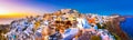 Panoramic view of Oia town, Santorini island, Greece at sunset. Royalty Free Stock Photo