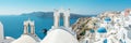 Panoramic view of Oia town with traditional and famous houses and churches with blue domes over the Caldera on Santorini island. Royalty Free Stock Photo