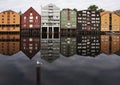 Panoramic view of old colorful wooden houses with reflections in river Nidelva in the Brygge district in Trondheim, Norway Royalty Free Stock Photo