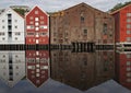 Panoramic view of old colorful wooden houses with reflections in river Nidelva in the Brygge district in Trondheim, Norway Royalty Free Stock Photo