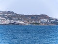 Panoramic view of Old Town Chora of Mykonos with tourists and sea