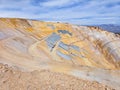 Panoramic view of one side of an open pit mine on a sunny morning with clear weather