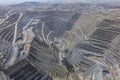 Panoramic view of open-pit mining operations process with heavy mining machinery Royalty Free Stock Photo
