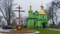 Panoramic view of orthodox wooden green church with golden domes and big wooden cross. Religion and Easter concept Royalty Free Stock Photo