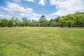 Panoramic view of the Osaka Castle Park with grassland in foreground and the cityscape in beackground