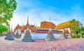 Panorama of Phra Ubosot surrounding wall with colorful chedis, Wat Pho complex in Bangkok, Thailand
