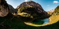 Panoramic view over blue mountain lake in swiss alps with house, switzerland Royalty Free Stock Photo