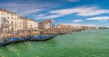 Panoramic view over busy Grand Canal, piers, promenade embankment, colorful buildings and Monument of King Victor Emmanuel II in