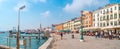 Panoramic view over busy with tourists crowds Venice, piers, outdoor restaurants, promenade embankment near Doge Palace and