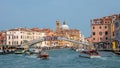 Panoramic view over busy with tourists Venice, piers, promenade embankment near Ferrovia, train station and bridge Ponte degli