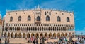 Panoramic view over cafe at the famous San Marco square in Venice, Italy, in front of the famous Doge Palace, at sunset with many Royalty Free Stock Photo