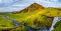 Panoramic view over camping site with tents and cars in front of famous Skogarfoss waterfall, while hiking in Iceland, summer Royalty Free Stock Photo
