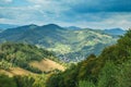 Panoramic view over the Carpatian mountains, green valleys and beautiful blue sky at the background Royalty Free Stock Photo