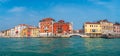 Panoramic view over colorful old houses in Venice, piers, outdoor restaurants, bridges, promenade embankment in Venice downtown,