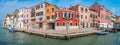 Panoramic view over colorful old houses in Venice, piers, outdoor restaurants, bridges, promenade embankment in Venice downtown,