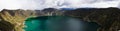 A panoramic view over the famous blue green Quilotoa lake in an old vulcano crater that can be found in the Andes of Ecuador, Royalty Free Stock Photo