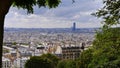 Panoramic view over the historic downtown of Paris, France from a viewpoint with trees on hill Montmartre. Royalty Free Stock Photo