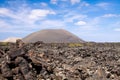 Panoramic view over lava field on crater and cone of red volcanoes in Timanfaya NP, Lanzarote, Canary Islands