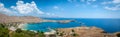 Panoramic view over local beach in an enclosed bay in Lindos village famous for an ancient Acropolis. Island of Rhodes. Greece. Royalty Free Stock Photo