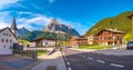 Panoramic view over magical Dolomite peaks, forests and hotels at sunny day and blue sky, Colfosco, Corvara, at Puez-Geisler, Puez