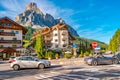 Panoramic view over magical Dolomite peaks, forests and hotels at sunny day and blue sky, Colfosco, Corvara, at Puez-Geisler, Puez