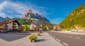 Panoramic view over magical Dolomite peaks, forests and hotels at sunny day and blue sky, Colfosco, Corvara, at Puez-Geisler, Puez