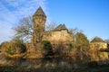 Panoramic view over moat on medieval water castle and defensive tower with bare trees in winter against blue sky - Krefeld Linn Royalty Free Stock Photo