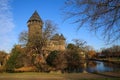 Panoramic view over moat on medieval water castle and defensive tower with bare trees in winter against blue sky - Krefeld Linn Royalty Free Stock Photo