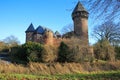 Panoramic view over moat on medieval water castle and defensive tower with bare trees in winter against blue sky - Krefeld Linn Royalty Free Stock Photo