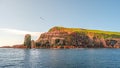 Panoramic view over mythical Faroe Island Mykines sunset in the middle of Atlantic Ocean with a lot of puffins, parrot like